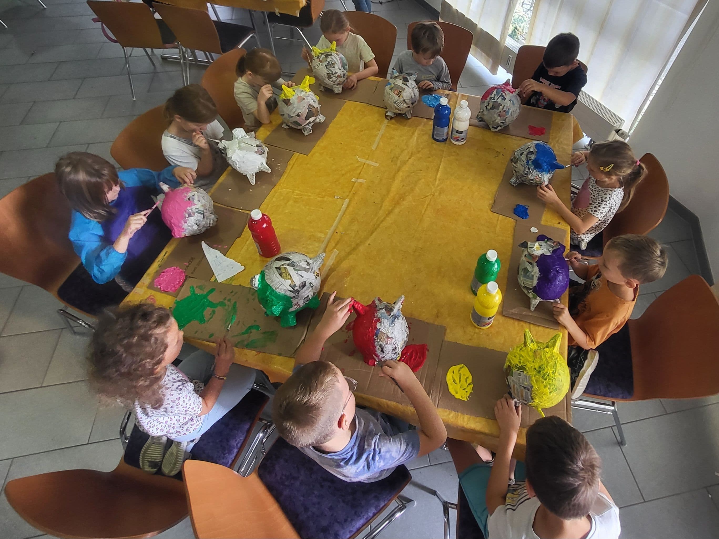 Kinder bemalen ihre beklebten Luftballons